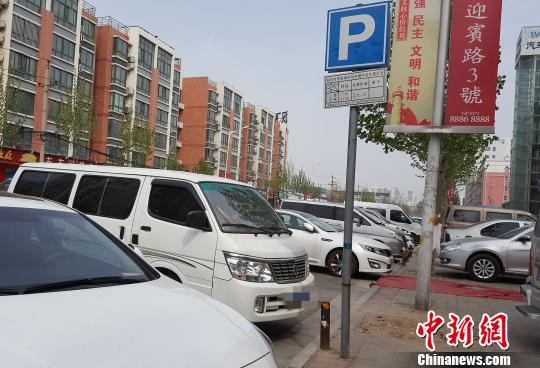 圖為鄭州市宏明路停車場公示牌顯示每次收費2元，而管理元每次卻收5元 齊永 攝