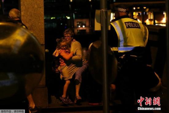 當地時間6月3日，英國倫敦相繼發生三起襲擊事件，導致至少一人死亡，多人受傷。警方確認，前兩起事件為恐怖襲擊，第三起襲擊事件與前兩起恐襲無關。圖為英國民眾抱孩子逃離恐襲事發地區。
