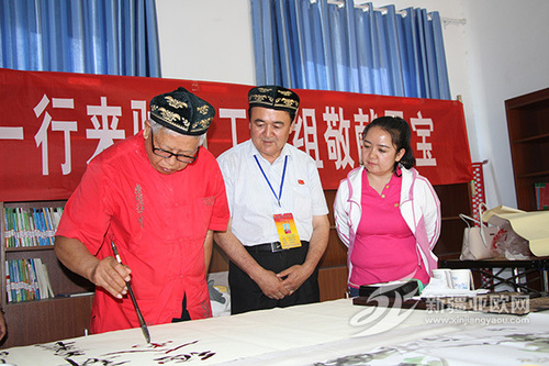 圖1:老書法張柱堂在自治區民政廳駐阿瓦提縣烏魯卻勒鎮庫木艾日克村工作隊創作